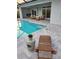 Inviting pool area features comfortable lounge seating and lush greenery at 14331 Montmarte Ave, Port Charlotte, FL 33981