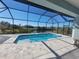 Screened pool offers relaxing view of a lake at 14331 Montmarte Ave, Port Charlotte, FL 33981