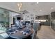 Open dining area with kitchen views, wood table, and modern chandelier at 14351 Howard Ave, Port Charlotte, FL 33953