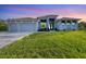 3-car garage home with lush landscaping at 14351 Howard Ave, Port Charlotte, FL 33953
