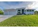 Beautiful contemporary home with three-car garage and lush lawn at 14351 Howard Ave, Port Charlotte, FL 33953
