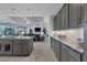 Spacious kitchen with gray cabinets, granite countertops, and stainless steel appliances at 14351 Howard Ave, Port Charlotte, FL 33953