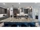 Eat-in kitchen with island seating, gray cabinets, granite countertops, and stainless steel appliances at 14351 Howard Ave, Port Charlotte, FL 33953
