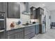 Modern kitchen with gray cabinets, granite counters, and stainless steel appliances at 14351 Howard Ave, Port Charlotte, FL 33953