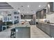 Open kitchen with large island, gray cabinets, granite countertops and stainless steel appliances at 14351 Howard Ave, Port Charlotte, FL 33953