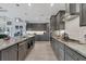 Open concept kitchen boasting gray cabinetry, granite countertops, and high-end appliances at 14351 Howard Ave, Port Charlotte, FL 33953