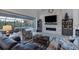 Open living room showcasing a stone fireplace and views to the pool at 14351 Howard Ave, Port Charlotte, FL 33953