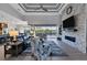 Spacious living room with stone fireplace, large TV, and access to pool area at 14351 Howard Ave, Port Charlotte, FL 33953