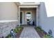 Covered entryway with stone accents, seating area, and landscaped walkway at 18651 Dayspring Pl, Venice, FL 34293