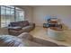 Living room with brown sofas, coffee table, and large window at 209 Broadmoor Ln, Rotonda West, FL 33947