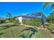 Private backyard oasis with a screened pool and lush landscaping at 2148 La Palma Ave, Port Charlotte, FL 33953