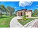Community building with arched entryway and landscaping at 2148 La Palma Ave, Port Charlotte, FL 33953