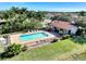 Aerial view of community pool with surrounding lounge chairs and cabana at 2148 La Palma Ave, Port Charlotte, FL 33953