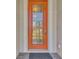 Attractive orange front door with a glass insert and decorative accents at 2148 La Palma Ave, Port Charlotte, FL 33953
