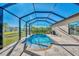 Refreshing screened pool with a spa and tiled deck at 2148 La Palma Ave, Port Charlotte, FL 33953