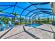 Inviting screened pool area with patio furniture, umbrella, and built-in spa at 2148 La Palma Ave, Port Charlotte, FL 33953