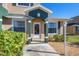 Front entrance of townhouse with green accents and landscaping at 222 Boundary Blvd # 222R, Rotonda West, FL 33947