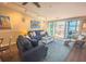 Bright living room with blue sofa, white coffee table, and water views at 2255 N Beach Rd # 9, Englewood, FL 34223