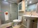 Clean bathroom with shower, toilet, and pedestal sink at 2255 N Beach Rd # 9, Englewood, FL 34223