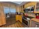 Modern kitchen with stainless steel appliances and light wood cabinets at 2255 N Beach Rd # 9, Englewood, FL 34223