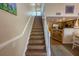 Staircase leading to upper level with kitchen and dining area visible at 2255 N Beach Rd # 9, Englewood, FL 34223