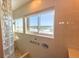 Walk-in shower with glass block wall and water views at 2255 N Beach Rd # 9, Englewood, FL 34223