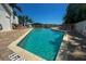 Community pool with lounge chairs and patio area at 2255 N Beach Rd # 9, Englewood, FL 34223