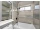 Clean bathroom with a bathtub and marble-look tile at 27168 Ipswich Dr, Englewood, FL 34223