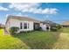 House exterior with a well-manicured lawn and screened patio at 27168 Ipswich Dr, Englewood, FL 34223