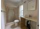 Small bathroom with shower and vanity awaiting renovation at 2930 Waterside Dr, Englewood, FL 34224