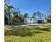 Single-wide mobile home with a shed and a large grassy yard at 2930 Waterside Dr, Englewood, FL 34224