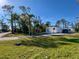 Single-wide mobile home on a spacious lot with mature trees at 2930 Waterside Dr, Englewood, FL 34224