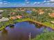 Aerial view of a home community with water features and lush landscaping at 3300 Pennyroyal Rd, Port Charlotte, FL 33953