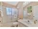 Clean bathroom with tub, shower, and updated vanity at 3300 Pennyroyal Rd, Port Charlotte, FL 33953