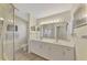 Double vanity bathroom with a shower and glass enclosure at 3300 Pennyroyal Rd, Port Charlotte, FL 33953
