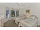 Bright bedroom with twin beds, window seating, and a ceiling fan at 3300 Pennyroyal Rd, Port Charlotte, FL 33953