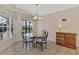 Bright breakfast nook with glass table and chairs, and view to pool at 3300 Pennyroyal Rd, Port Charlotte, FL 33953