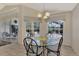 Kitchen breakfast nook with glass table and chairs, overlooking pool at 3300 Pennyroyal Rd, Port Charlotte, FL 33953