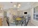 Casual dining area with glass table and chairs, open to kitchen at 3300 Pennyroyal Rd, Port Charlotte, FL 33953