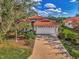 Attractive single-story home with a tile roof and landscaped yard at 3300 Pennyroyal Rd, Port Charlotte, FL 33953