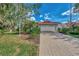 Single-story home with a large driveway and landscaped yard at 3300 Pennyroyal Rd, Port Charlotte, FL 33953