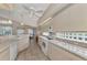 Open kitchen with white appliances and view to dining area at 3300 Pennyroyal Rd, Port Charlotte, FL 33953