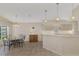 Kitchen and breakfast nook with tiled floor and light wood cabinetry at 3300 Pennyroyal Rd, Port Charlotte, FL 33953
