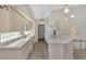 Galley style kitchen, featuring white appliances and ample counter space at 3300 Pennyroyal Rd, Port Charlotte, FL 33953