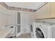 Laundry room with washer, dryer, and utility sink at 3300 Pennyroyal Rd, Port Charlotte, FL 33953