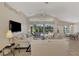 Comfortable living area featuring a large TV and access to a pool at 3300 Pennyroyal Rd, Port Charlotte, FL 33953