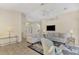 Bright living room featuring a neutral color palette, tiled floors, and comfortable seating at 3300 Pennyroyal Rd, Port Charlotte, FL 33953