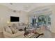 Relaxing living room with flat-screen TV and sliding glass doors at 3300 Pennyroyal Rd, Port Charlotte, FL 33953