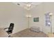 Home office with desk, chair, and ample natural light at 3300 Pennyroyal Rd, Port Charlotte, FL 33953