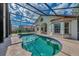 Relaxing kidney-shaped pool with screened enclosure at 3300 Pennyroyal Rd, Port Charlotte, FL 33953